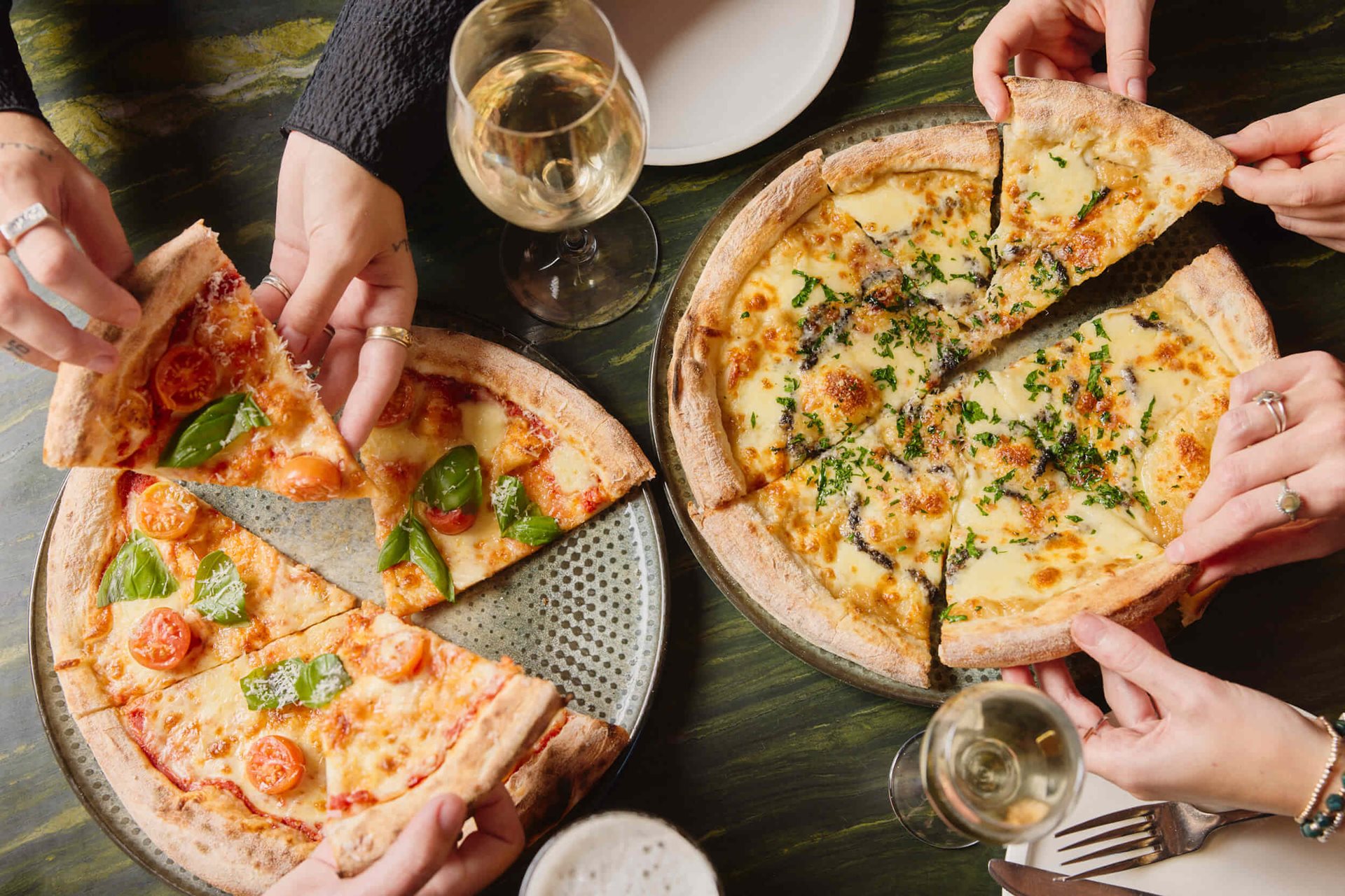 Shared pizzas and drinks at The Squire's Landing Brewhouse
